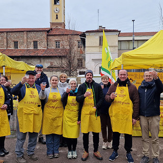 persone vestite di giallo in gruppo davanti a un gazebo