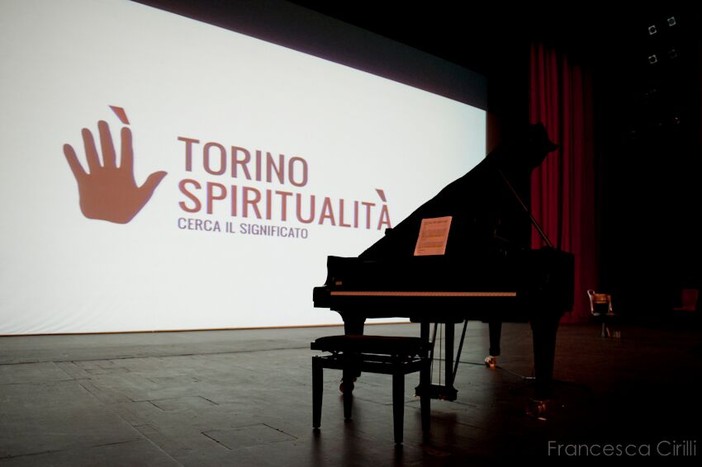 Un pianoforte di fronte alla scritta di Torino Spiritualità